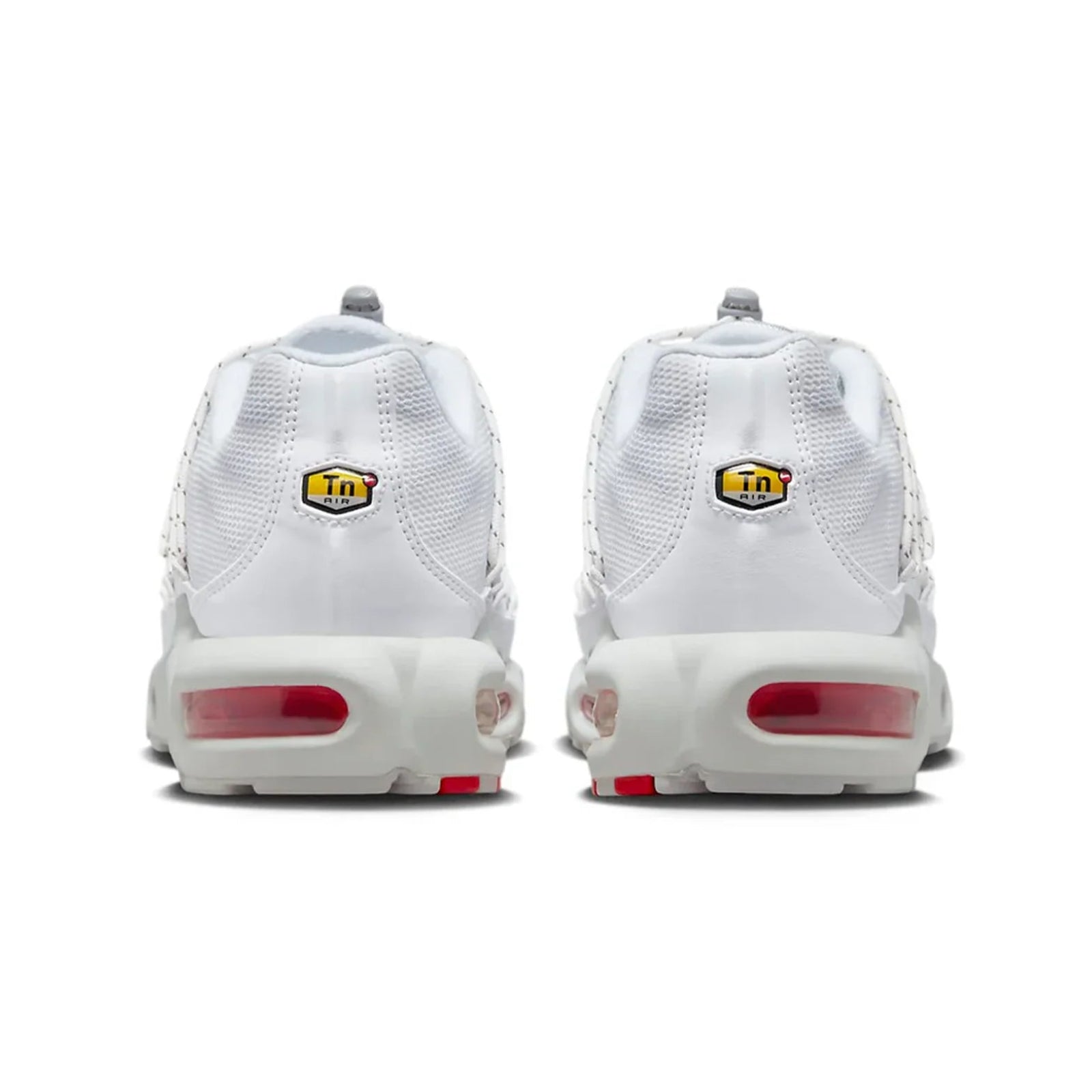 White sneakers with red airbags and yellow logos on a white background