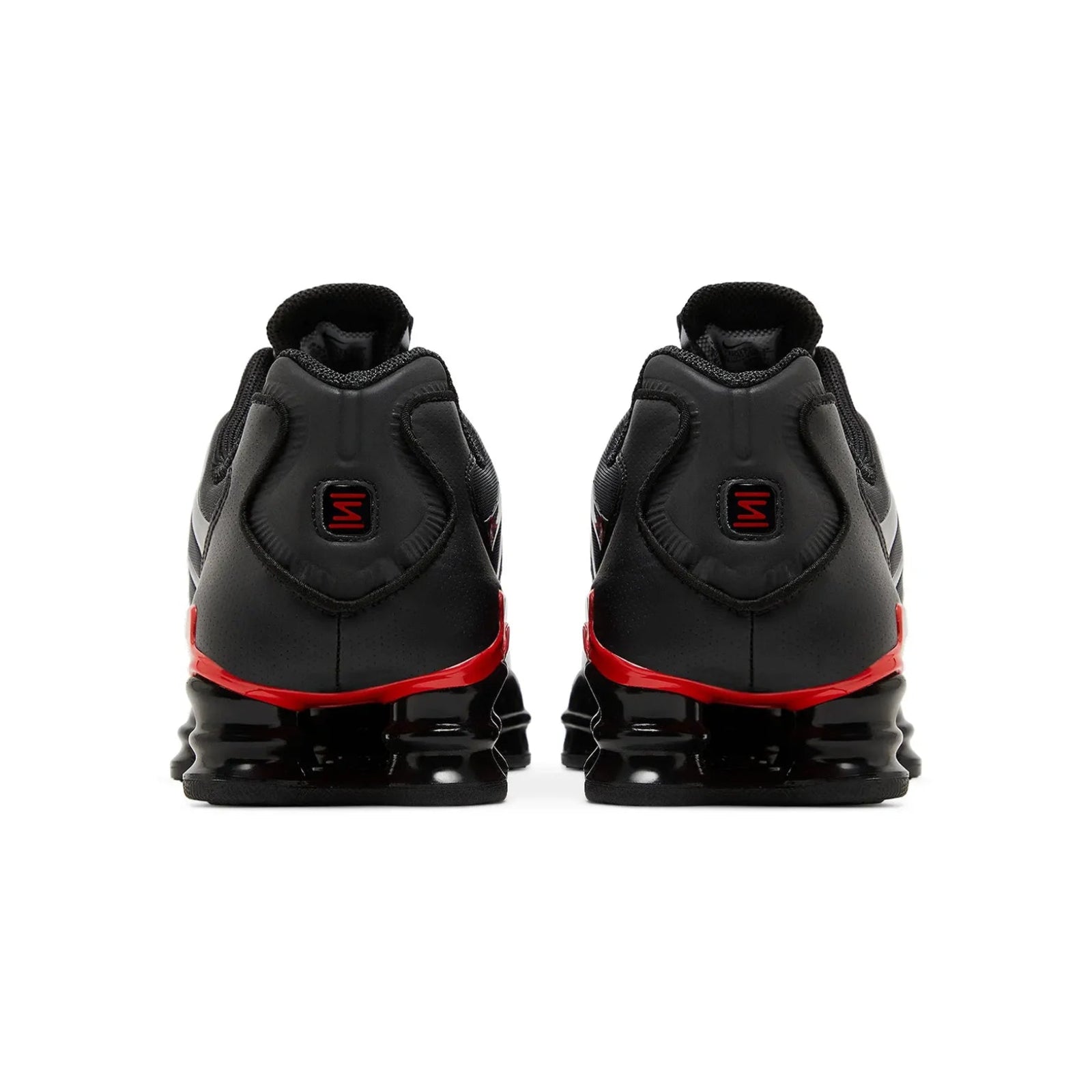 Black and red athletic shoes on a white background