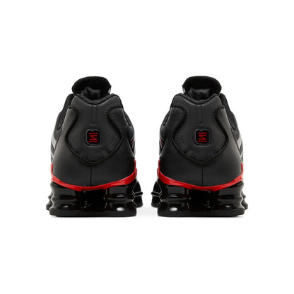 Black and red athletic shoes on a white background