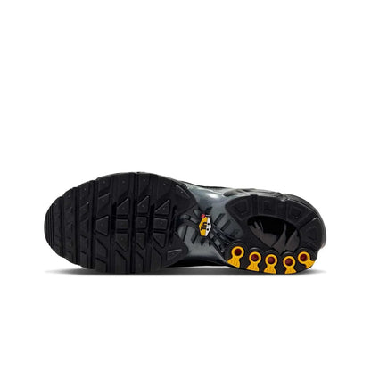 Black boot sole with yellow accents on a white background