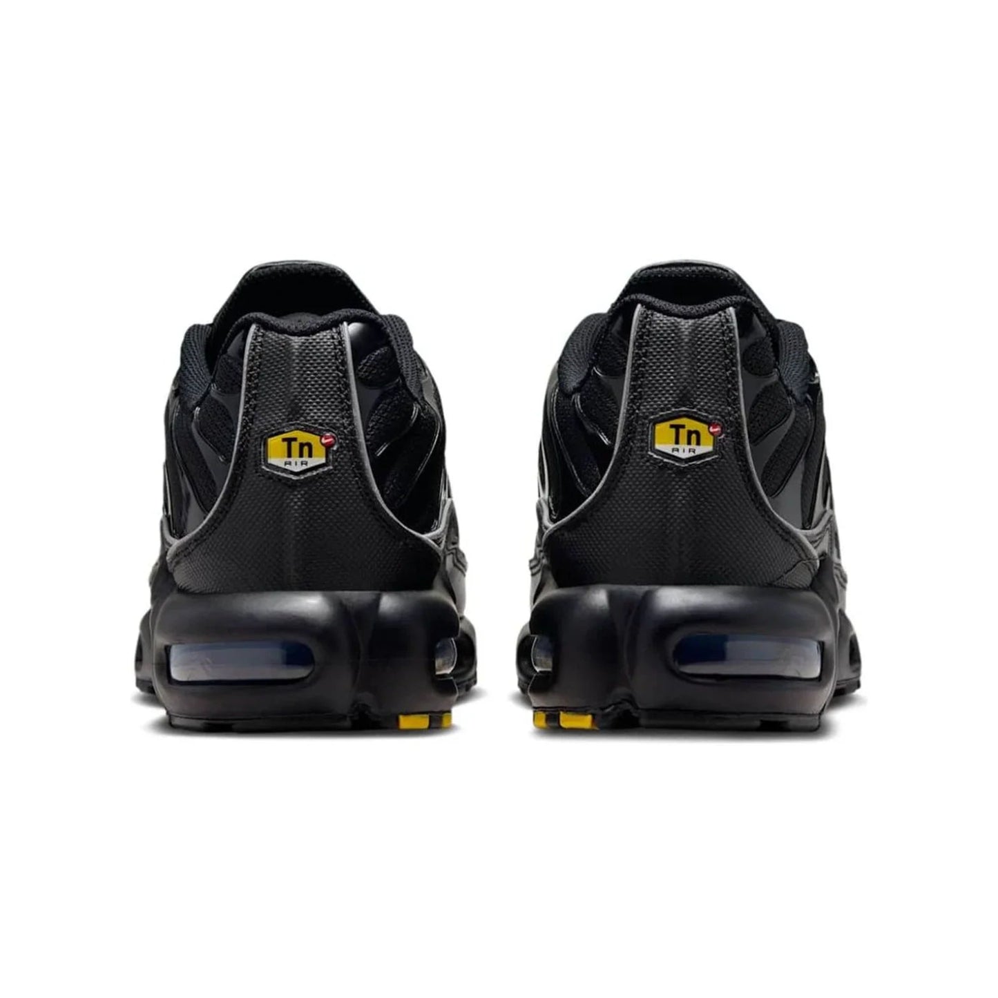 Black sneakers with yellow accents on a white background