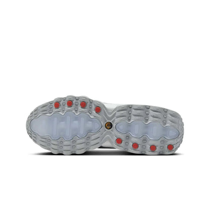Close-up of a shoe sole with red accents on a white background