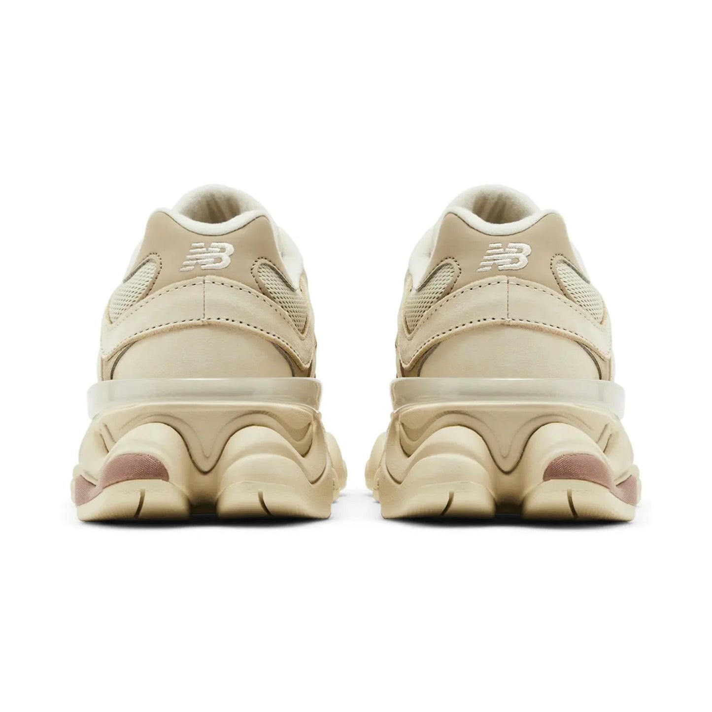 Pair of beige sneakers with a brand logo on a white background