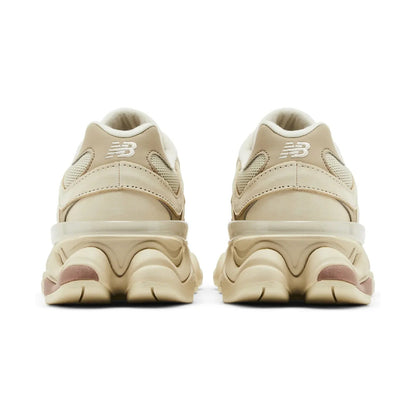 Pair of beige sneakers with a brand logo on a white background