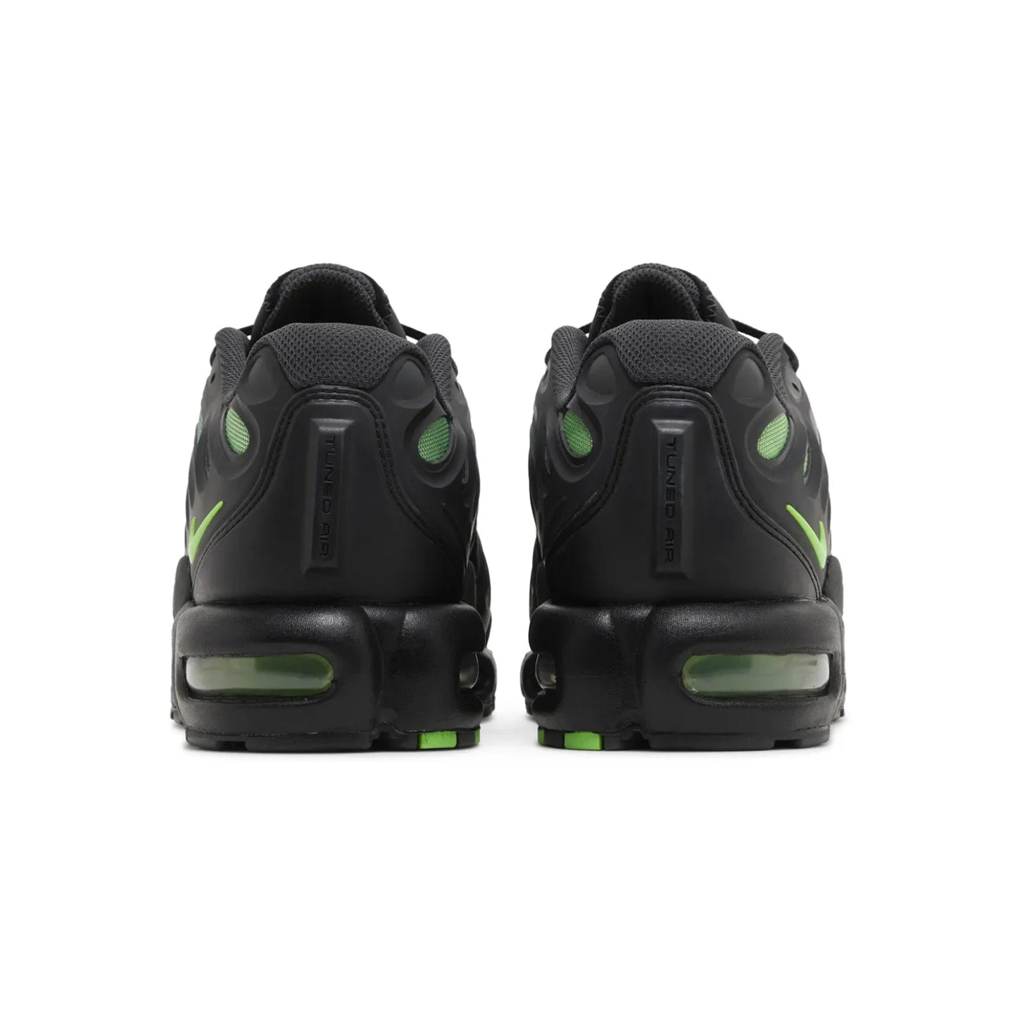 Black sneakers with green accents on a white background
