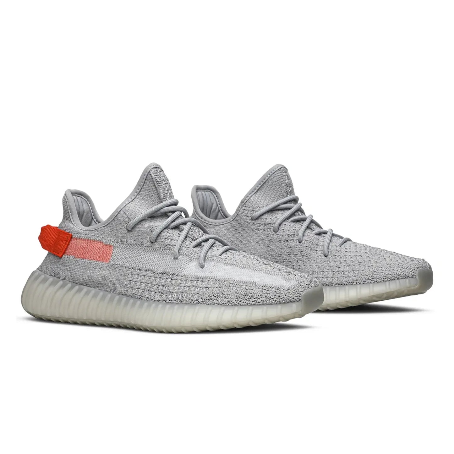 Gray sneakers with a red tag on a white background