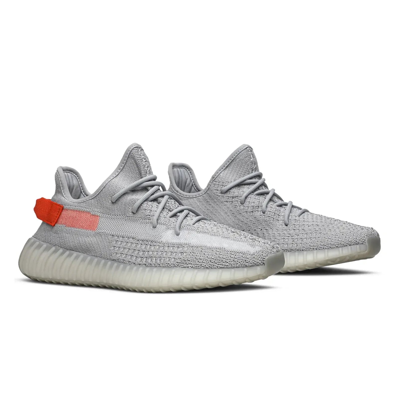 Gray sneakers with a red tag on a white background