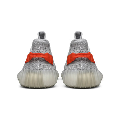 Gray sneakers with orange accents on a white background