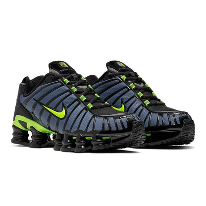 Pair of black and blue athletic shoes with green accents on a white background