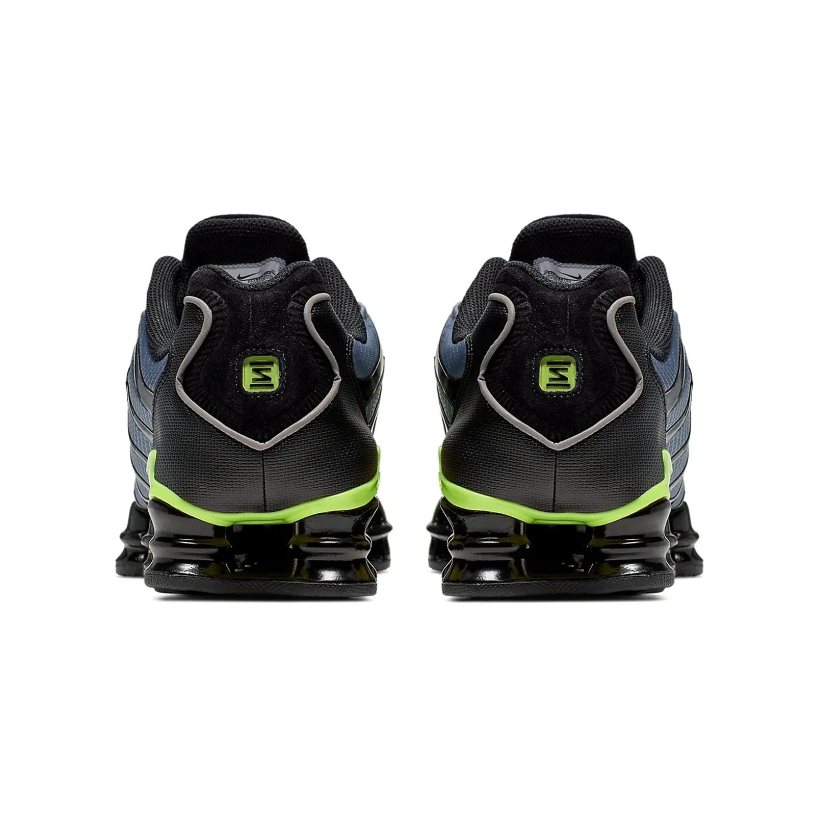 Black and green athletic shoes on a white background