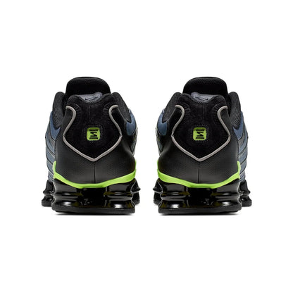 Black and green athletic shoes on a white background