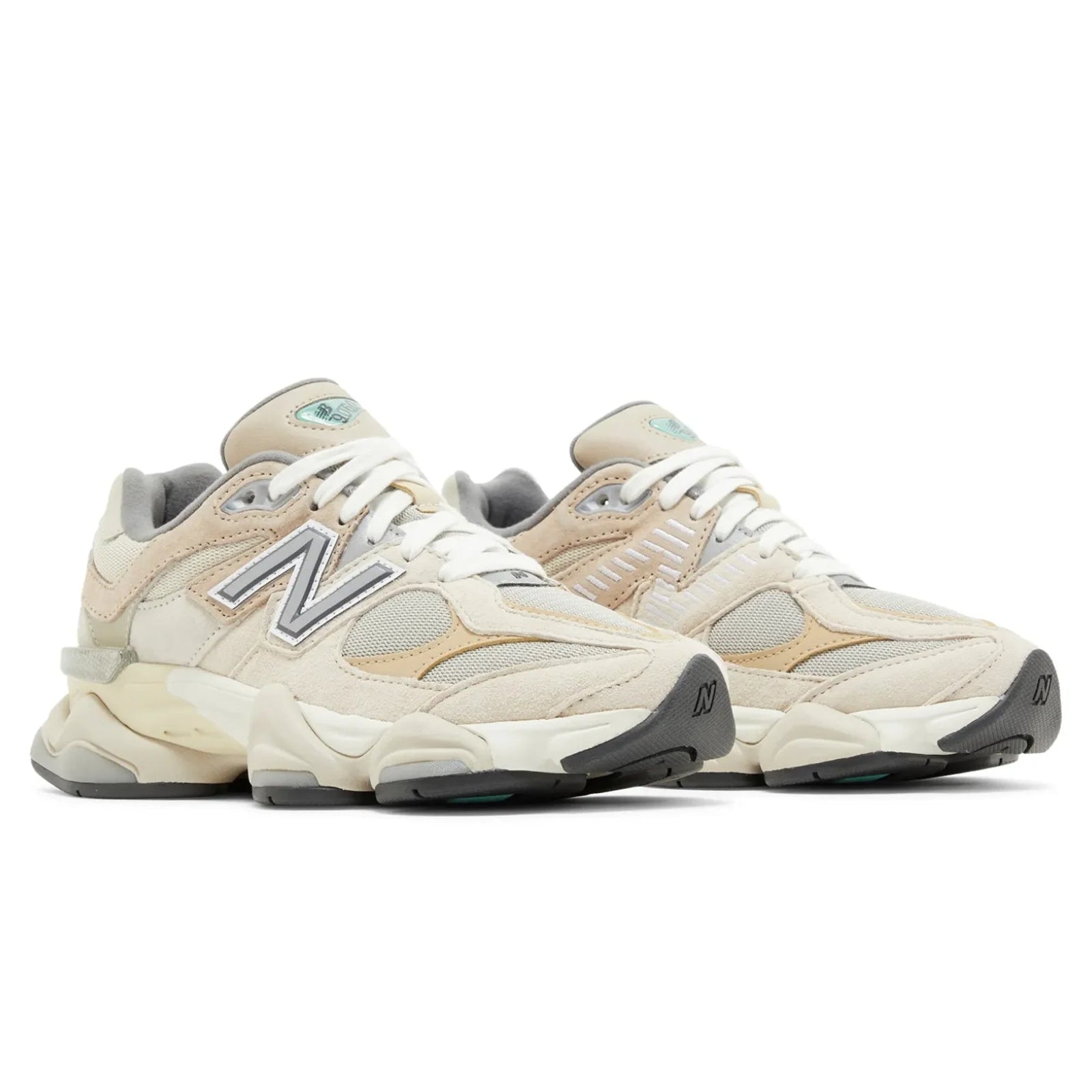 Pair of beige sneakers with New Balance logo on a white background