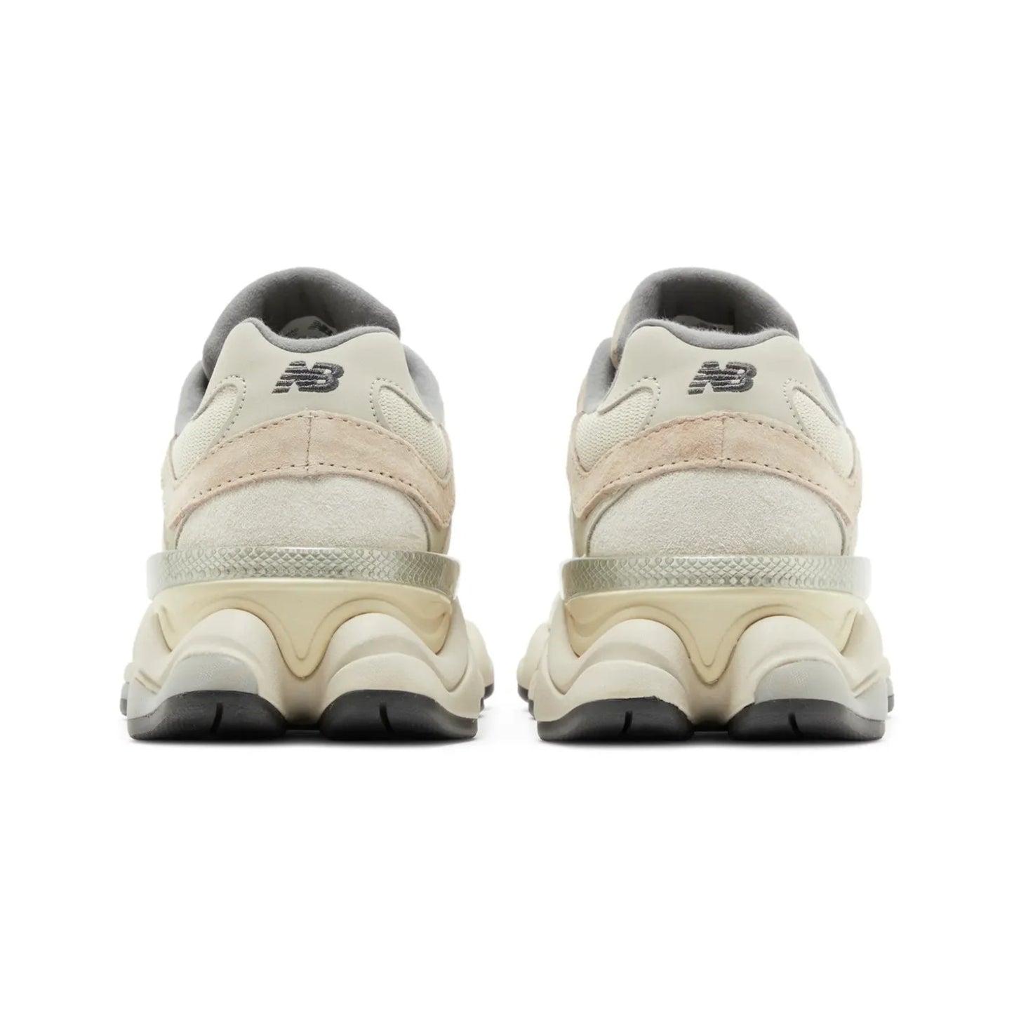 Pair of beige sneakers with black soles on a white background