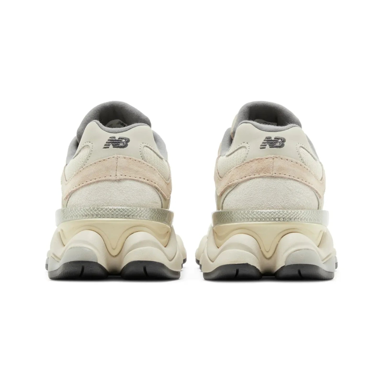 Pair of beige sneakers with black soles on a white background