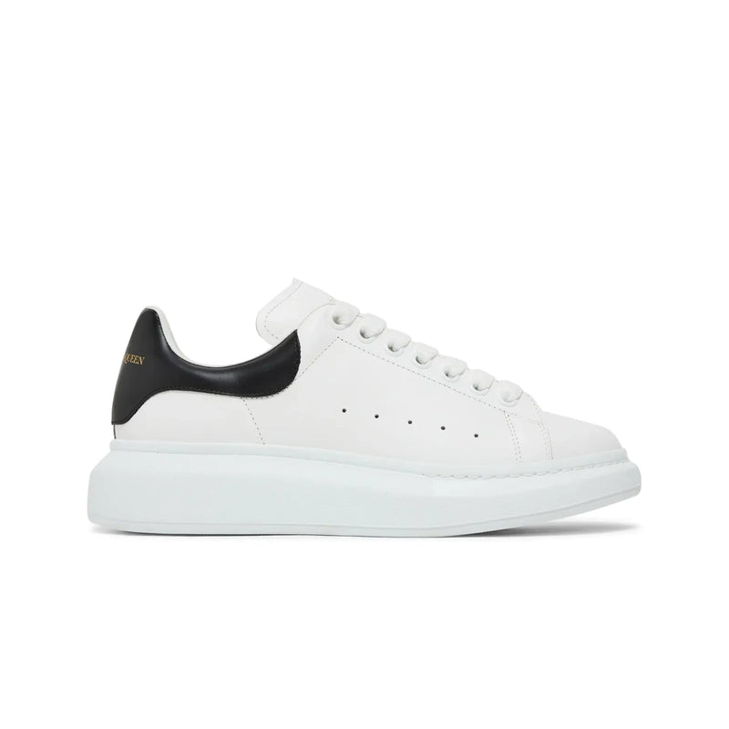 White sneaker with black heel on a white background