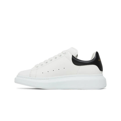 White sneaker with black heel on a white background