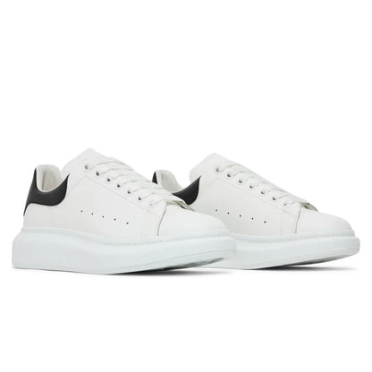 White sneakers with black accents on a white background