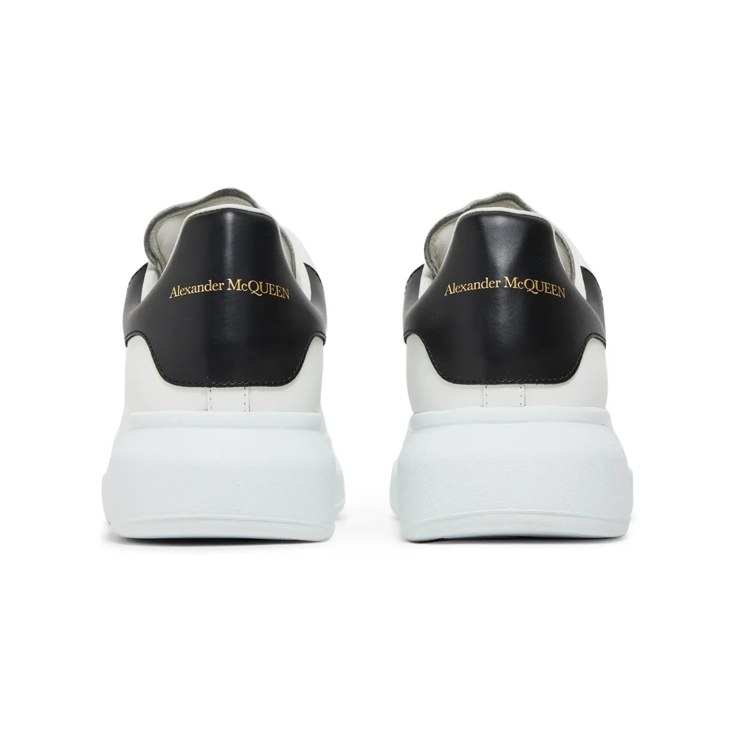 Black and white sneakers with 'Alexander McQueen' branding on a white background