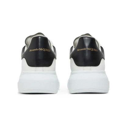 Black and white sneakers with 'Alexander McQueen' branding on a white background