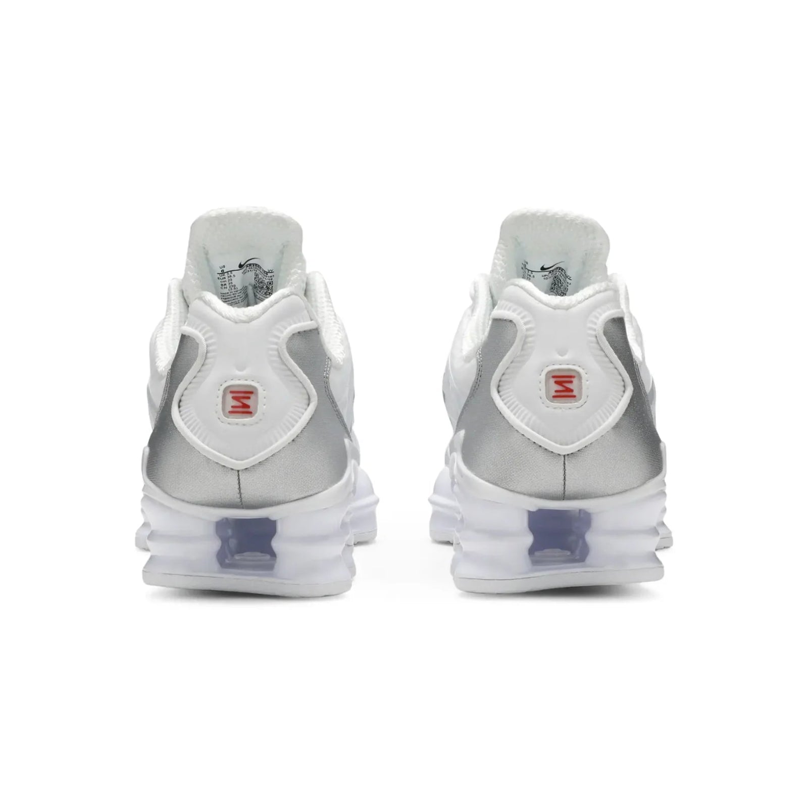Pair of silver and white sneakers on a white background