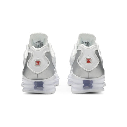 Pair of silver and white sneakers on a white background