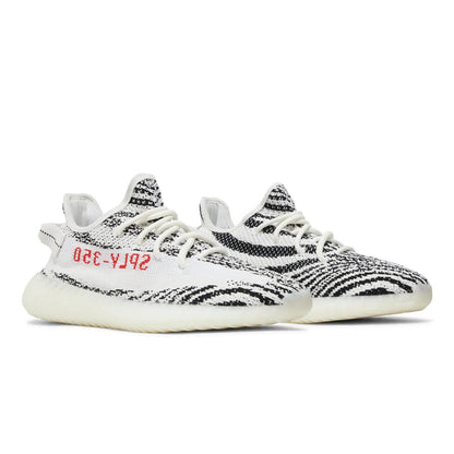 Black and white sneakers with red text on a white background