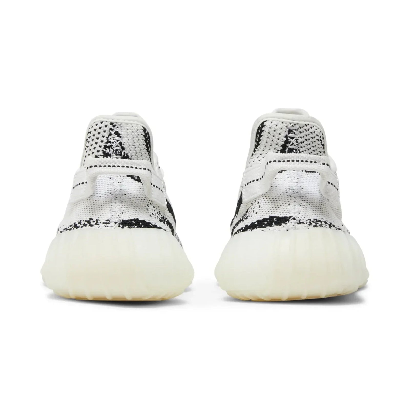 Pair of white sneakers with black speckles on a white background